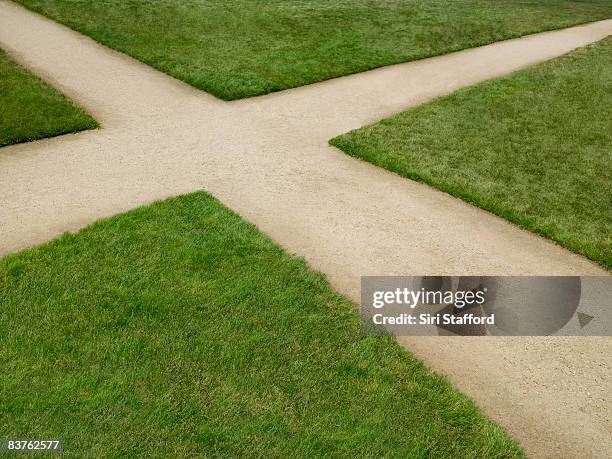 dirt crossroad surrounded by grass - crossroad stock pictures, royalty-free photos & images