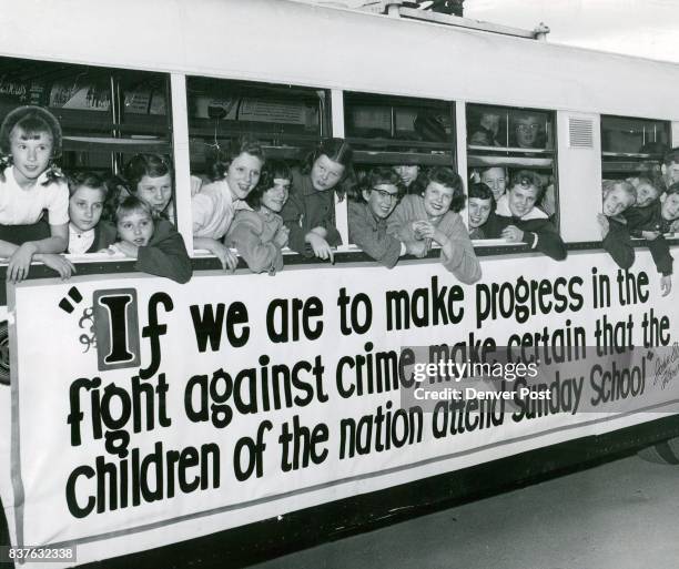 Members of the youth council of Bethel Baptist church crowd up to the windows of a special i white bus furnished by the Denver Tramway Corp. During a...