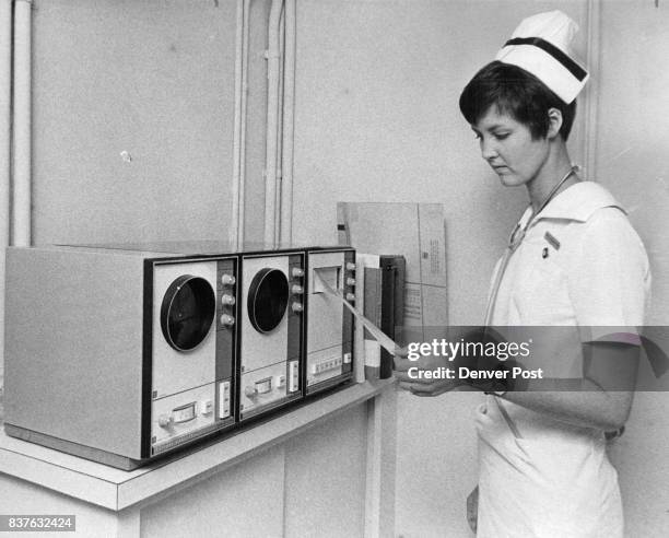 Lori Sullivan, Boulder, assistant head nurse, checks the tape on the hospital's new central cardiac monitor machines, used for constant check....