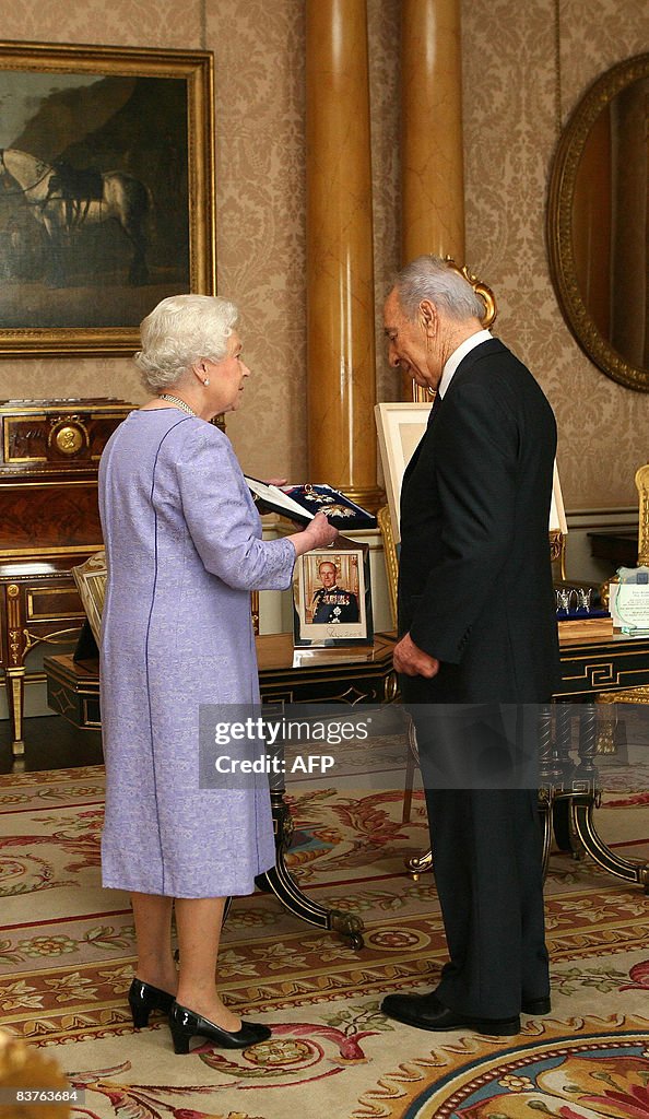 Britain's Queen Elizabeth II (L) receive