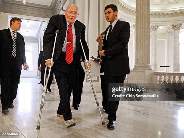 House Energy and Commerce Committee Chairman John Dingell arrives on crutches for the House Democratic Caucus meeting on Capitol Hill November 20,...