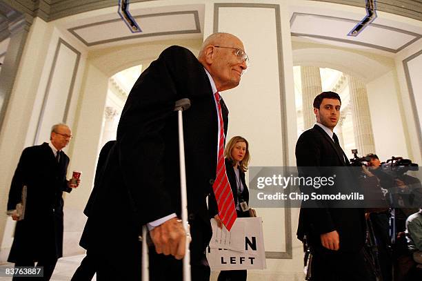 House Energy and Commerce Committee Chairman John Dingell arrives on crutches for the House Democratic Caucus meeting on Capitol Hill November 20,...