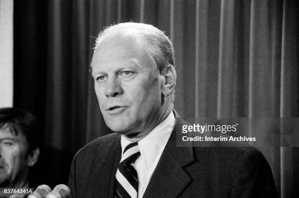 Close-up of American politician US President Gerald Ford as he speaks into a bank of microphones during a press conference, Washington DC, August 9,...