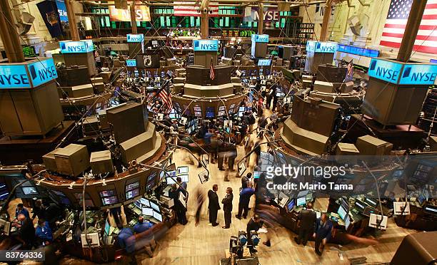 Traders work on the floor after the morning bell at the New York Stock Exchange November 20, 2008 in New York City. Stocks were down again in morning...