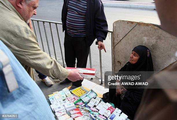 An Iraqi refugee woman sells cigarettes on the side of a road in the Jordanian capital Amman on November 20, 2008. The Iraqi embassy in Amman...