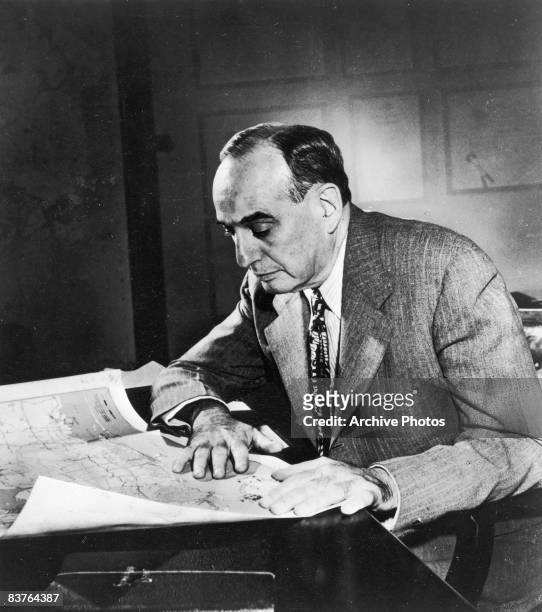 American urban planner and New York City Parks Department Commissioner Robert Moses , Robert Moses works with a map at his desk, 1958.