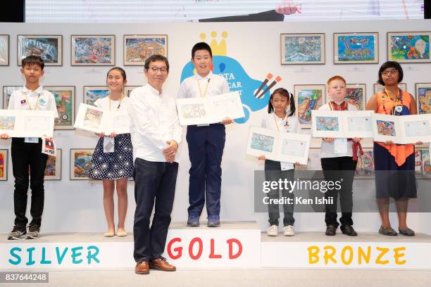 Hong Yu Liang of Canada, gold award winner of age 8 to 11 category for 'The Suitcase Car', receives the gold prize during the 11th Toyota Dream Car...