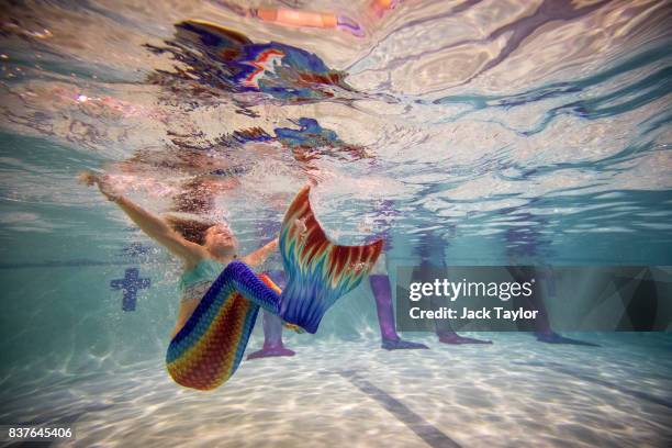 Mermaiding students swim in their tails during a Mayim Mermaid Academy lesson at the swimming pool at Bournemouth Collegiate School on August 19,...