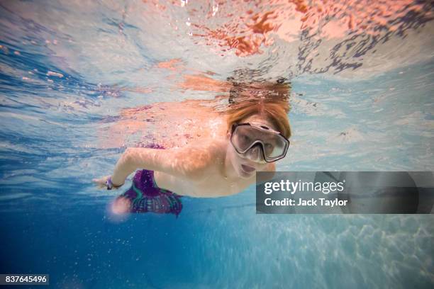 Mermaiding student Fin Hatcher, age 12, swims during a Mayim Mermaid Academy lesson at the swimming pool at Bournemouth Collegiate School on August...