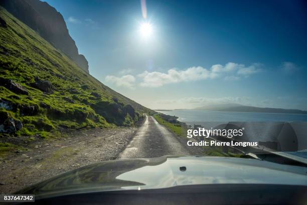 car driving on the coastal narrow road b8035 on the shore of loch na keal, principal sea loch on atlantic coastline of the island of mull, in the inner hebrides, argyll and bute, scotland. - sea loch stock pictures, royalty-free photos & images