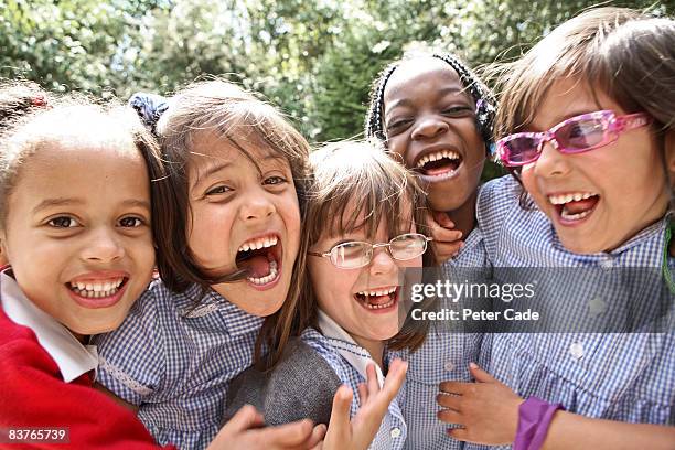 school girls laughing together - alleen meisjes stockfoto's en -beelden