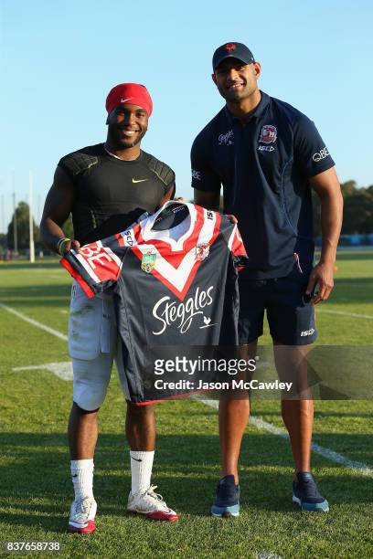Bryce Love of Stanford University is presented with a jersey from Daniel Tupou of the Roosters during a US College Football Media Opportunity at...