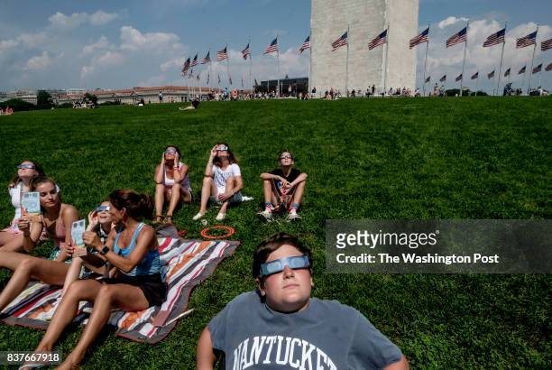 Liam Crowley views the solar eclipse with friends and family on the National Mall in Washington, DC on August 21, 2017. Crowley is from New York...