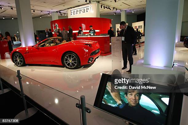 Classic film clips involving Farraris show next to a 460 horse power Ferrari California sports car during the Los Angeles Auto Show press preview...