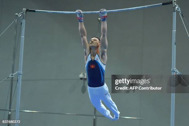 Vietnam's Dinh Phuong Thanh competes in the men's artistic gymnastics horizontal bars final event of the 29th Southeast Asian Games in Kuala Lumpur...