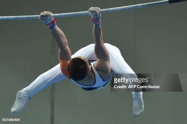 Vietnam's Dinh Phuong Thanh competes in the men's artistic gymnastics horizontal bars final event of the 29th Southeast Asian Games in Kuala Lumpur...