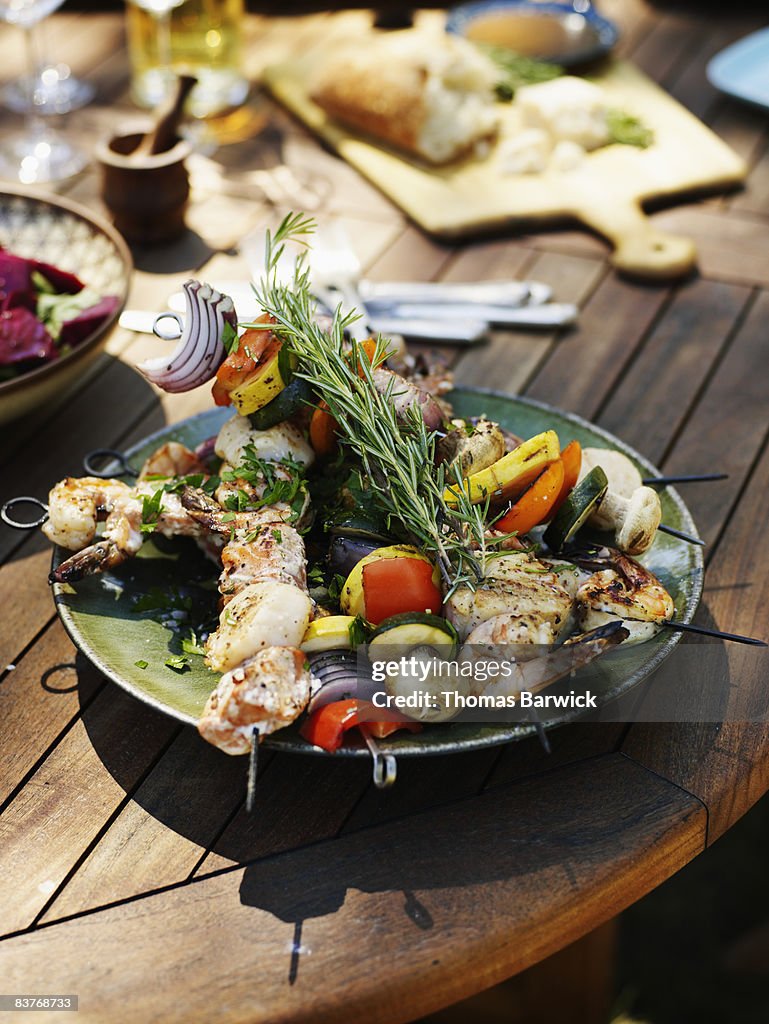 Plate of grilled prawns, scallops and vegetables