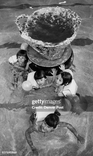Buoyed Up for Show Undersize swimmers and an outsize cup and saucer are elements in the "Mad Hatter's Ride" number of the YWCA Water Show. The...