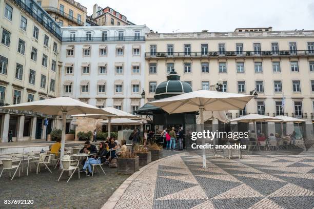 people relaxing in cafe on praca do municipio, lisbon, portugal - municipio stock pictures, royalty-free photos & images
