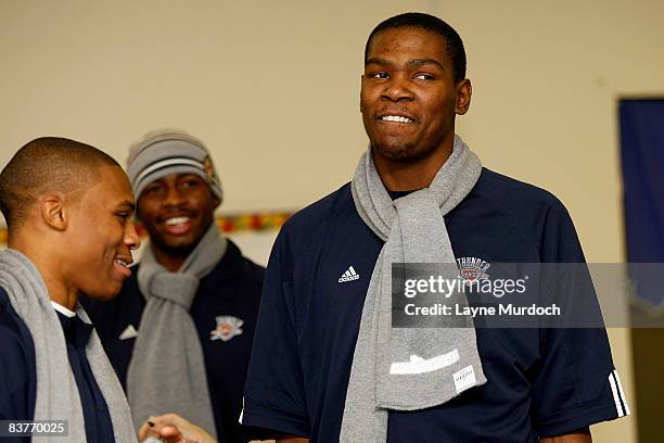 Desmond Mason, Kevin Durant and Russell Westbrook of the Oklahoma City Thunder participates in the Oklahoma City Thunder Holiday Assist charitable...