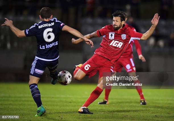 Leigh Broxham of the Victory competes for the ball with Vince Lia of United during the round of 16 FFA Cup match between Adelaide United and...