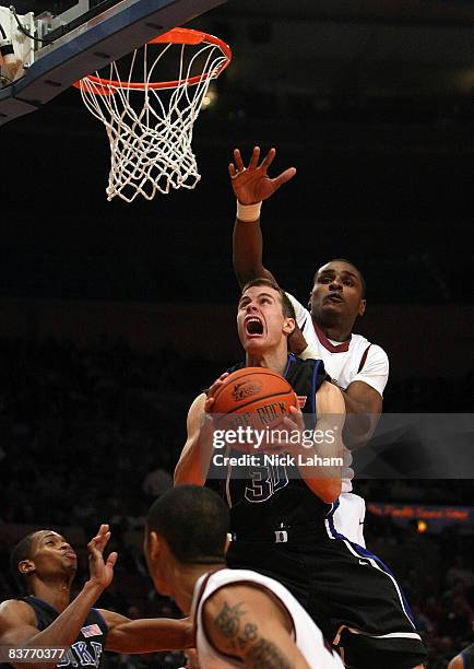 Jon Scheyer of the Duke Blue Devils drives to the basket against the Southern Illinois Salukis on November 20, 2008 at Madison Square Garden in New...