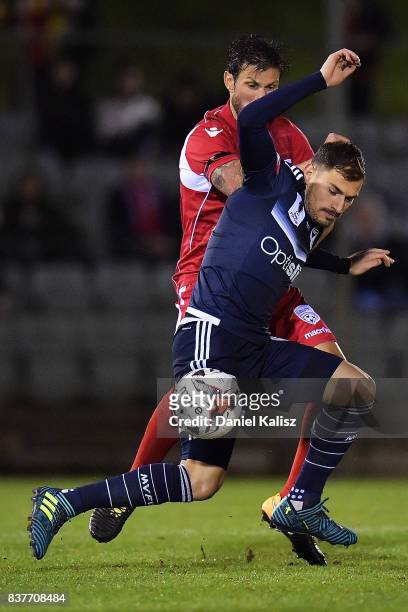 James Troisi of the Victory competes for the ball with Vince Lia of United during the round of 16 FFA Cup match between Adelaide United and Melbourne...