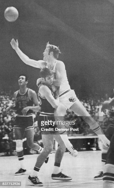 Couldn't Clear the Obstacle Dudley Mitchell of the University of Colorado couldn't avoid a collision, with Bob Kivisto of Kansas and the CU guard is...