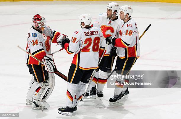 Goaltender Miikka Kiprusoff of the Calgary Flames is congratulated by his teammates Robyn Regehr, Todd Bertuzzi and Wayne Primeau after his shutout...