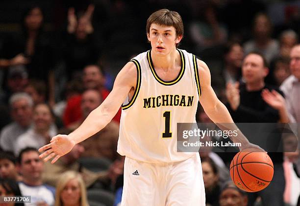 Stu Douglass of the Michigan Wolverines dribbles the ball upcourt against the UCLA Bruins at Madison Square Garden November 20, 2008 in New York...