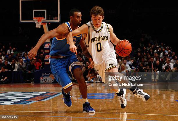 Zack Novak of the Michigan Wolverines dribbles past Josh Shipp of the UCLA Bruins at Madison Square Garden November 20, 2008 in New York City, New...