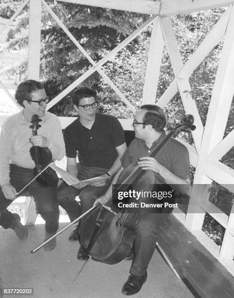 David Gillis, left, Upper Darby,Pa.,Bruce Hangen, center,Great Falls, Mont., and Peter Wukovitz, Montvale, N.J., get together in the gazebo to work...