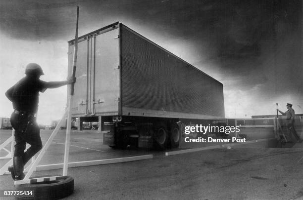 While a Denver policeman and Colorado state patrolmen, acting as graders, watch, truck driver tries to parallel park. It was part of the Colorado...