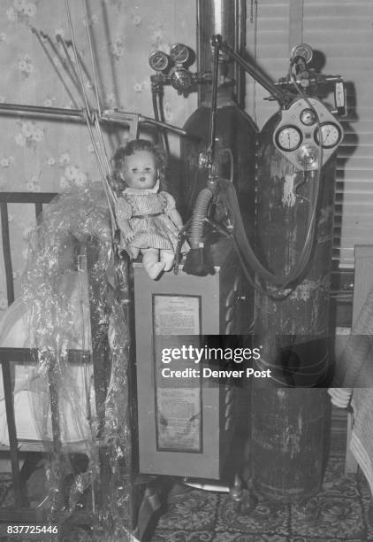 Oxygen tanks and a small blond doll constant companion of Vyvienne Groves who died Thursday at Children's Hospital, are left in her Arvada home after...