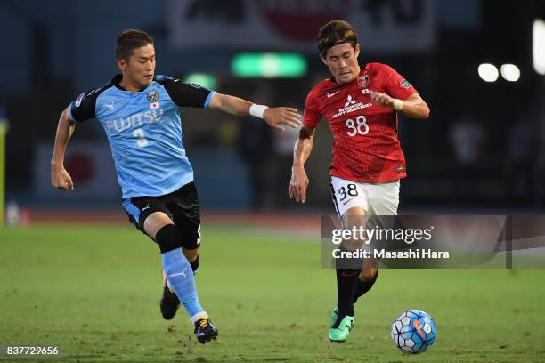 Daisuke Kikuchi of Urawa Red Diamonds and Tatsuki Nara of Kawasaki Frontale compete for the ball during the AFC Champions League quarter final first...