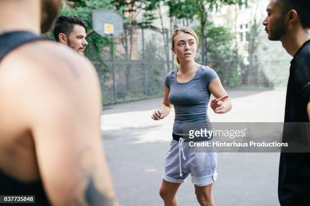 young athletic woman picking teammates before basketball match - court notice bildbanksfoton och bilder