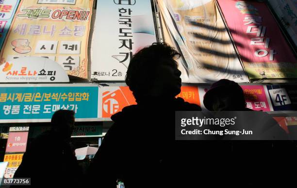 Shoppers are seen at the Namdaemun shopping district on November 21, 2008 in Seoul, South Korea. The Korean won nosedived against the dollar and...