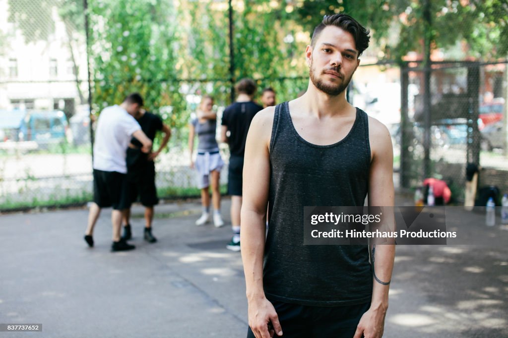 Young Athletic Man At Basketball Court, Ready To Play With Friends