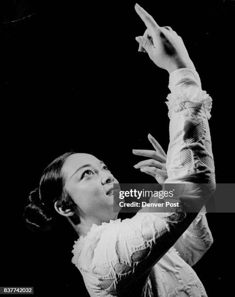 Gomez Raises Her Hands To Hawaiian Fire Goddess Pele ***** "tuu tuu muu," grandma's gown, introduced by white missionaries. Credit: Denver Post