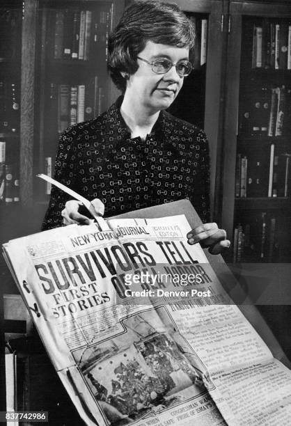 Curator of the documentary resources department of the Colorado State Museum, holds newspaper &- clippings of the disaster of the Titanic in 1912...