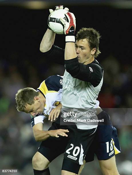 Danny Vukovic of the Mariners collides with teammate Alex Wilkinson during the round 12 A-League match between the Melbourne Victory and the Central...