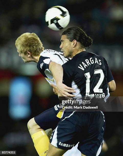 Matt Simon of the Mariners competes with Rodrigo Vargas of the Victory during the round 12 A-League match between the Melbourne Victory and the...