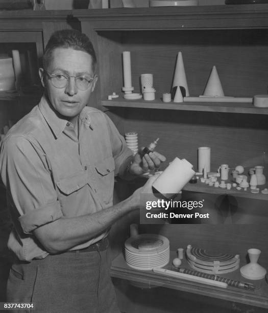 Adolph Coors III displays two of the many rador, radio and television parts manufactured at the Coors Porcelain Co. In his right hand is a radar...
