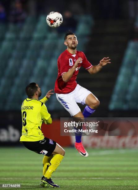 Michael Neill of Sydney United 58 FC heads the ball in front of Adrian Zahra of Heidleberg United during the FFA Cup round of 16 match between Sydney...