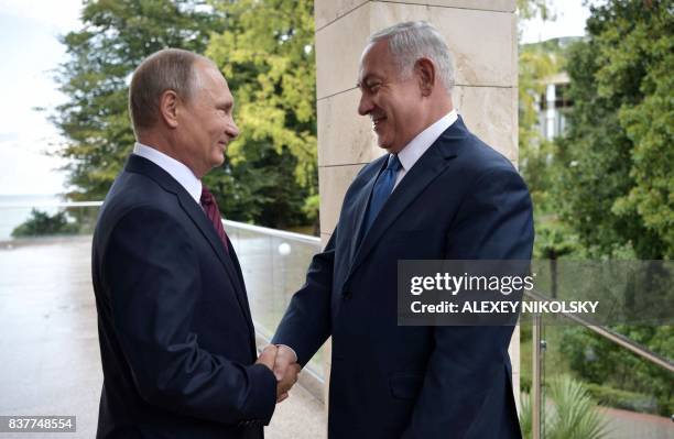 Russian President Vladimir Putin welcomes Israeli Prime Minister Benjamin Netanyahu during a meeting at the Bocharov Ruchei state residence in Sochi...