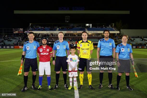 Captains Nicholas Stavroulakis of Sydney United 58 FC and Luke Byles of Heidleberg United pose with referees after the coin toss during the FFA Cup...