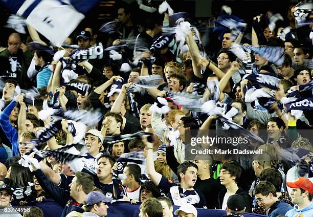 Victory fans wave their scarves during the round 12 A-League match between the Melbourne Victory and the Central Coast Mariners at the Telstra Dome...