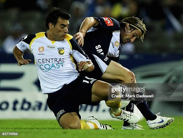 Adrian Caceres of the Mariners competes with Nick Ward of the Victory during the round 12 A-League match between the Melbourne Victory and the...