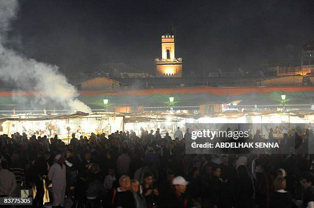 People gather at Place Jemaa Elfna in Marrakech for an open-air projection of US Barry Levinson film Rain Man during the Marrakesh film festival, on...