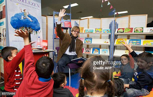 Former Belgian Prime Minister Guy Verhofstadt reads a story for children at the library Brugse Poort in Gent during the Reading breakfast of the Read...